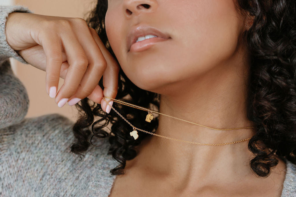 A women is wearing her dog's silhouette pendant necklace made in Canada.