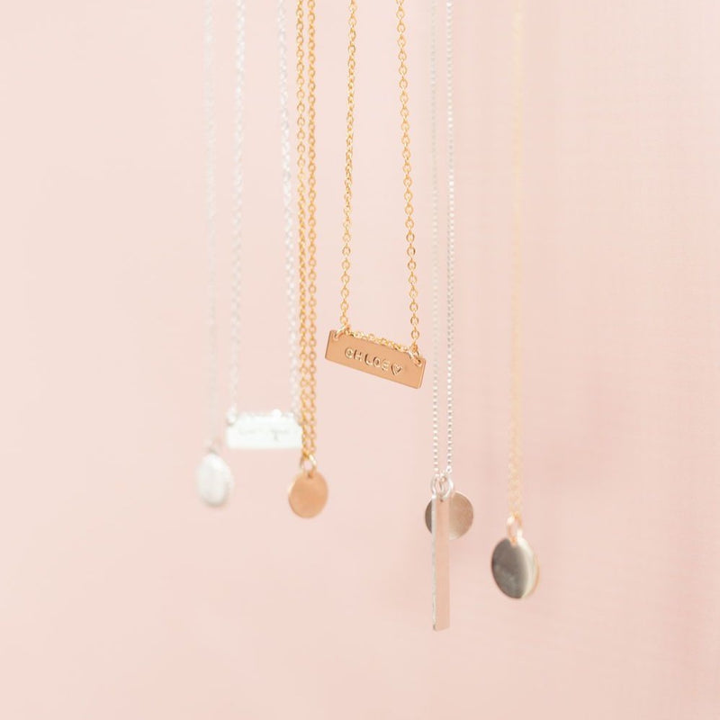 Variety of custom handmade coin and bar necklaces in sterling silver, gold and rose gold