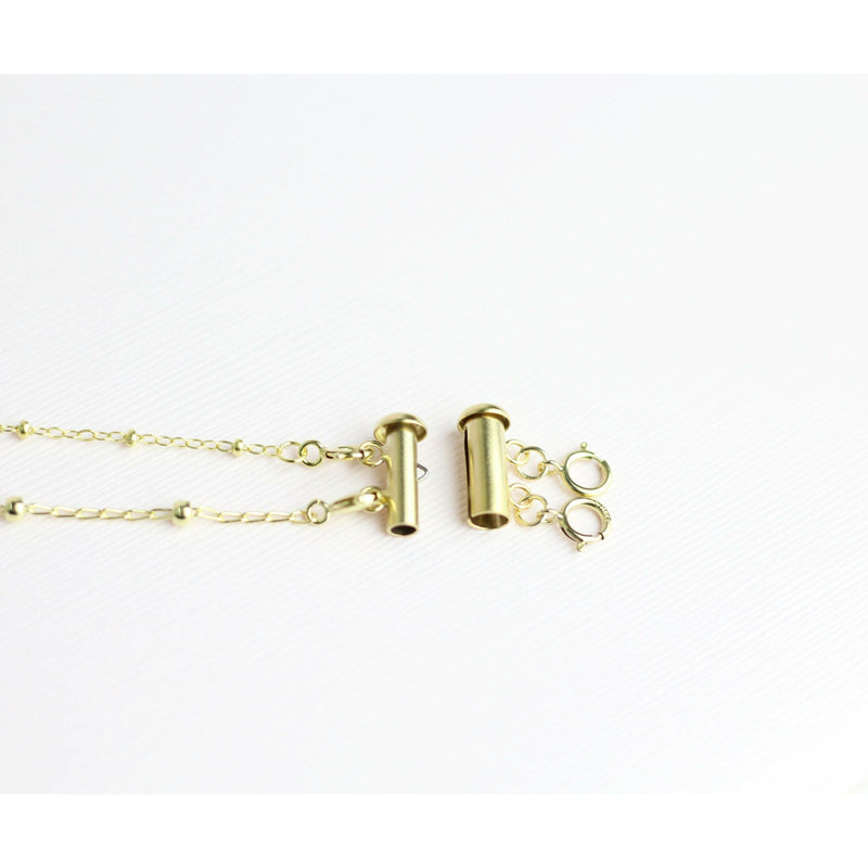 clasp to keep necklaces from tangling together in gold 
