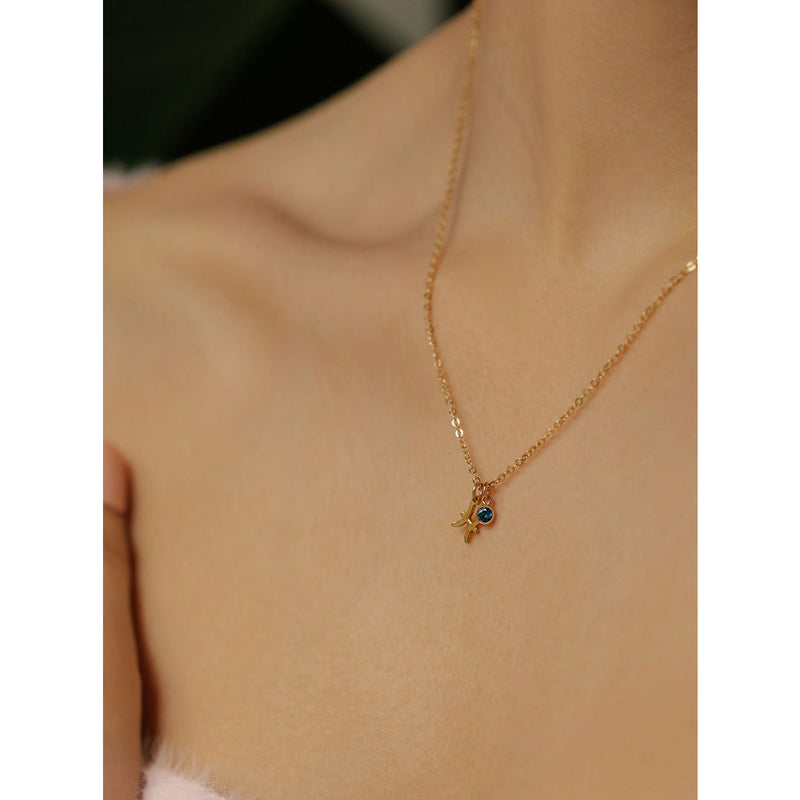a lady is wearing a zodiac necklace with birthstone made in Canada