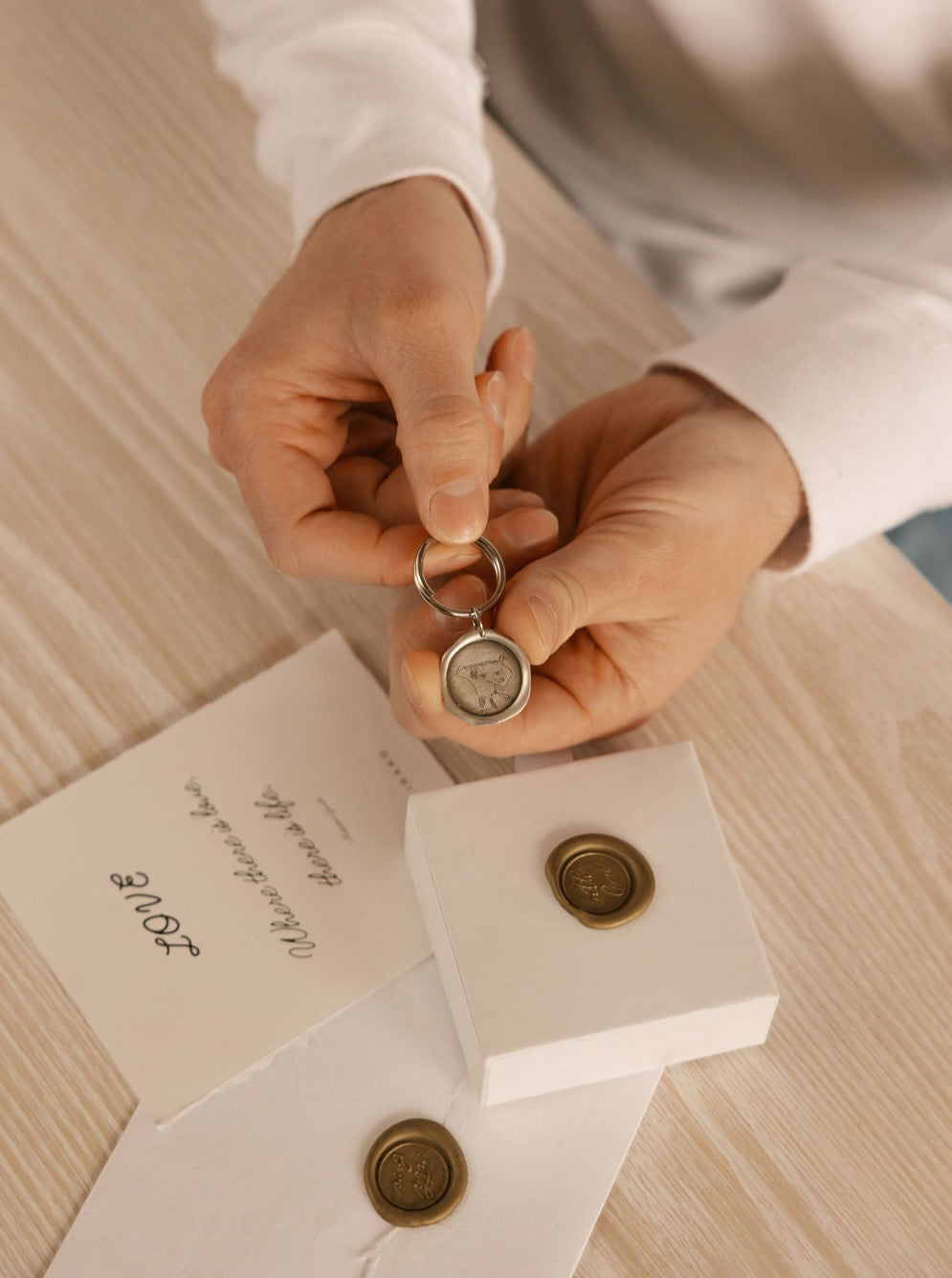 a man is holding a personalized key chain made in Canada