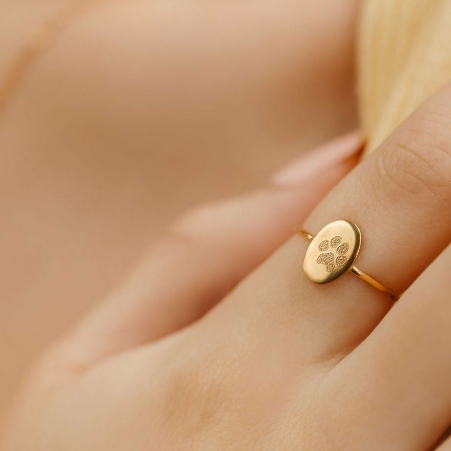 a lady wearing a gold filled pet print ring
