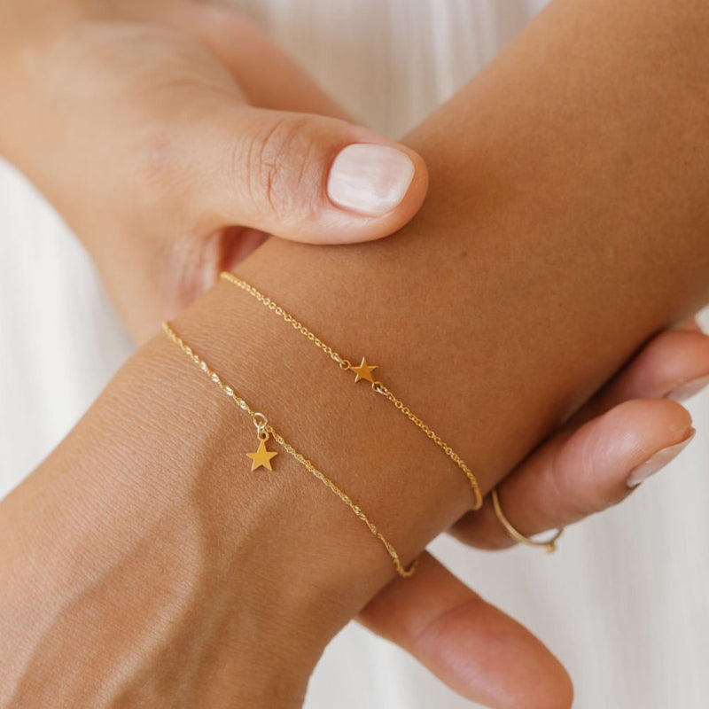 a woman is wearing star bracelets stack made in Canada