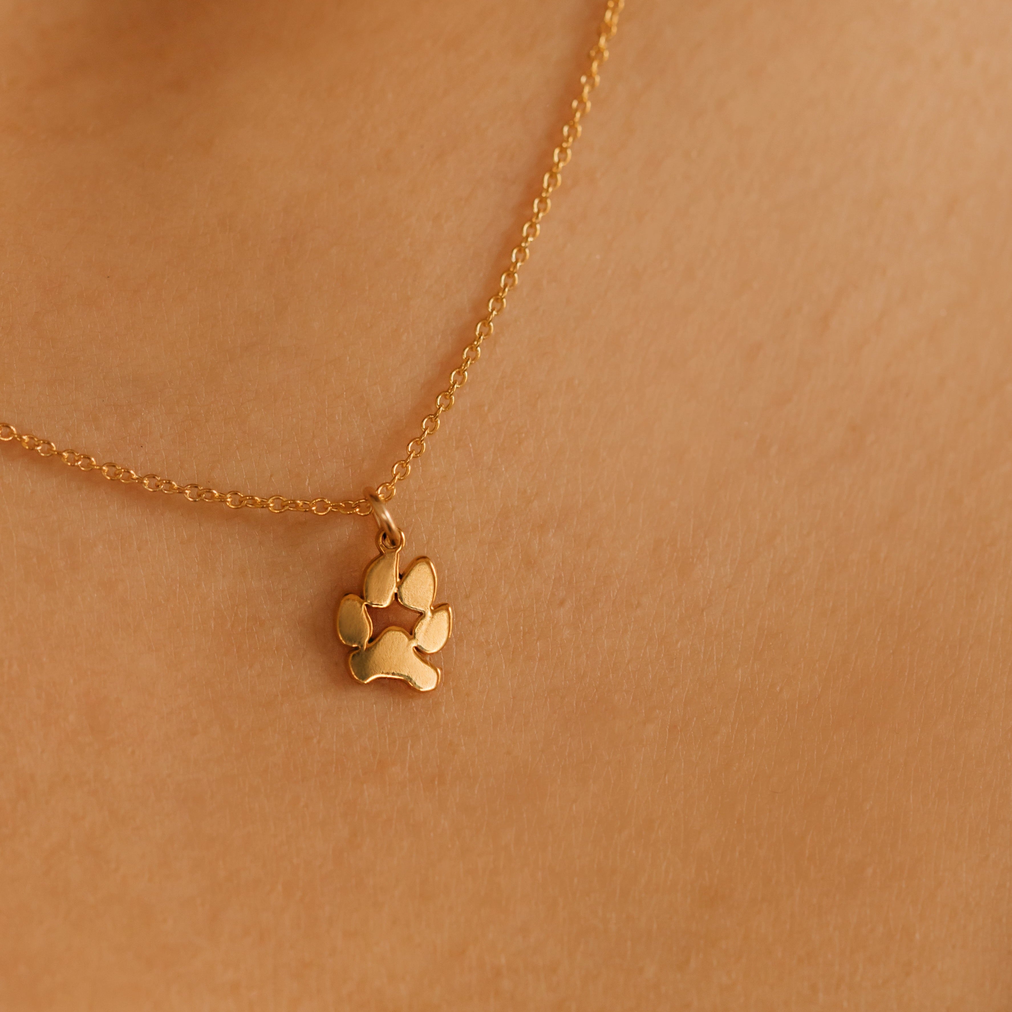 a gold personalized paw print necklace made in Canada