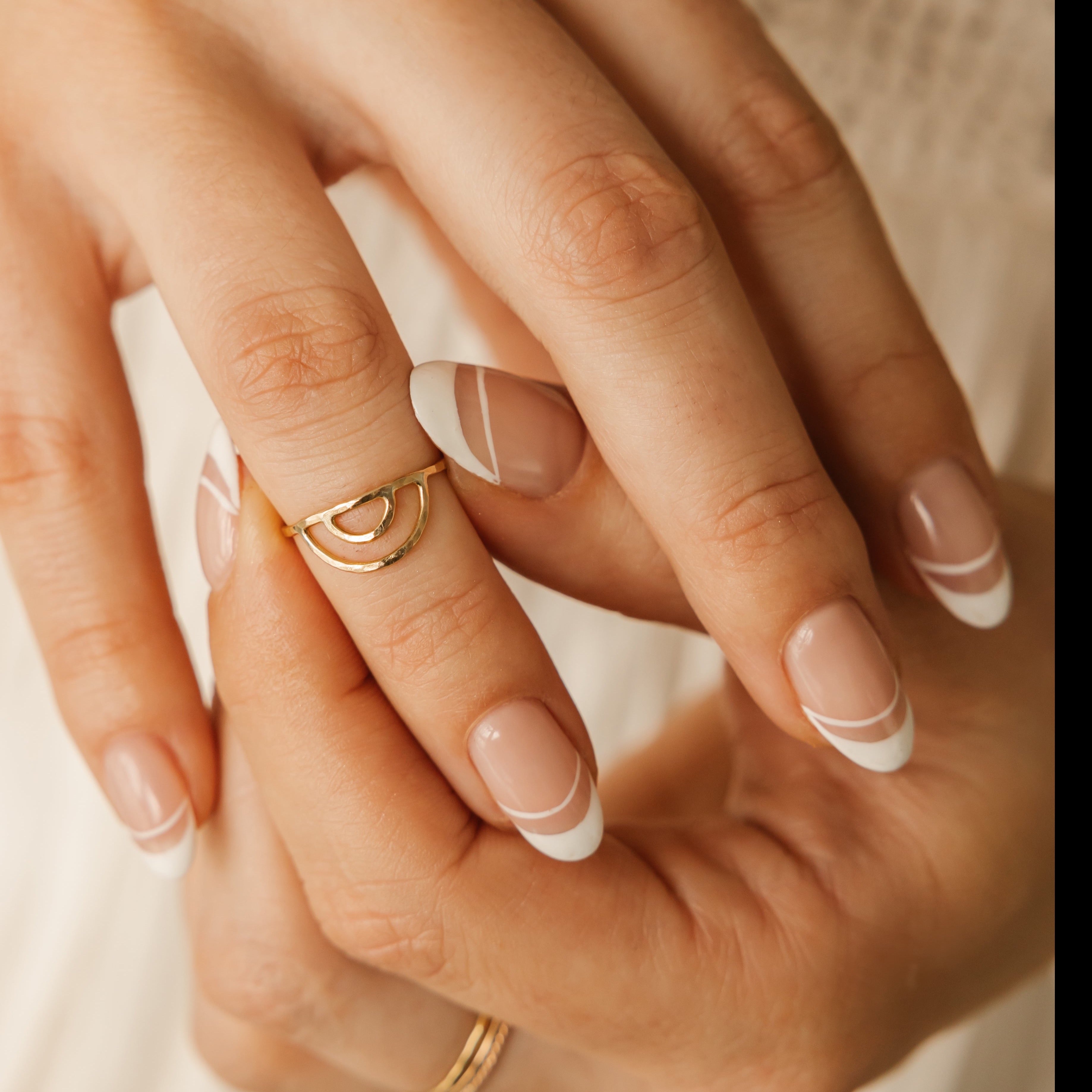 a woman is wearing anti-tarnished rainbow stackable ring made in Canada