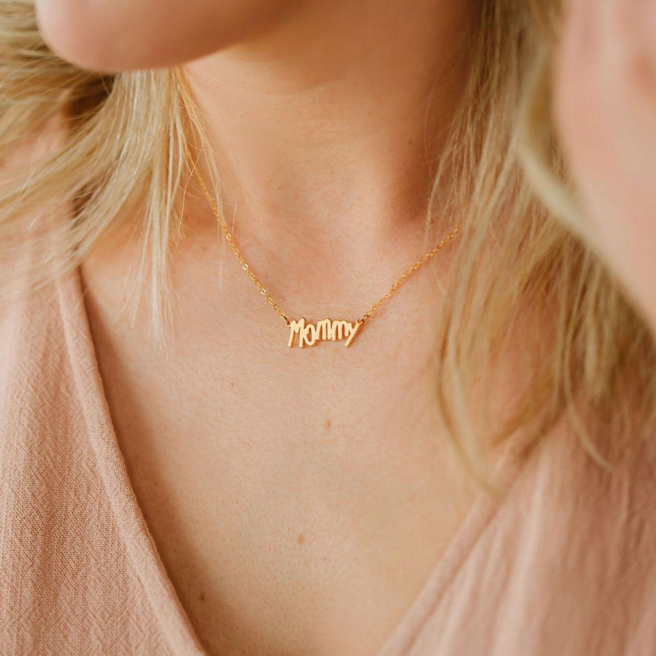 Woman wearing necklace made from her daughter's handwriting