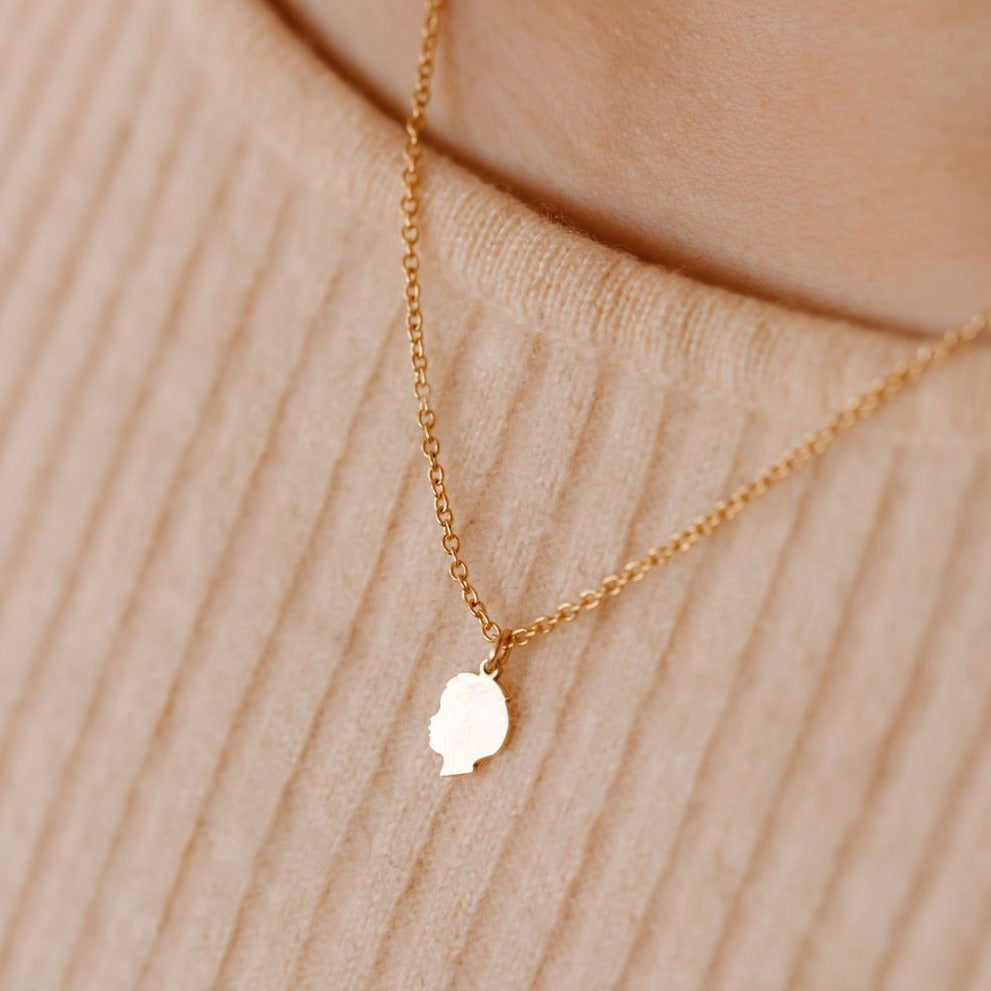 silhouette of child necklace in solid gold