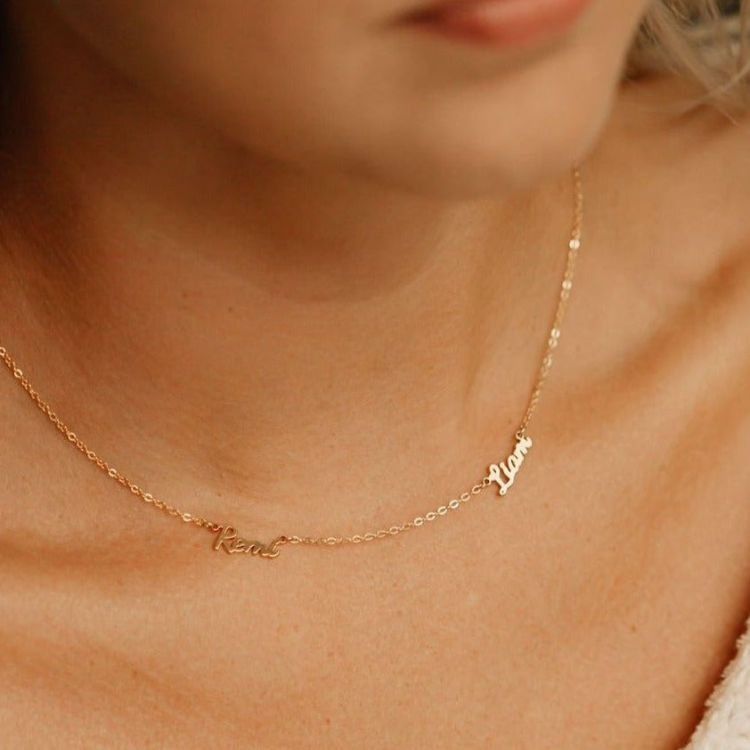 Mom wearing gold necklace with her kids names 
