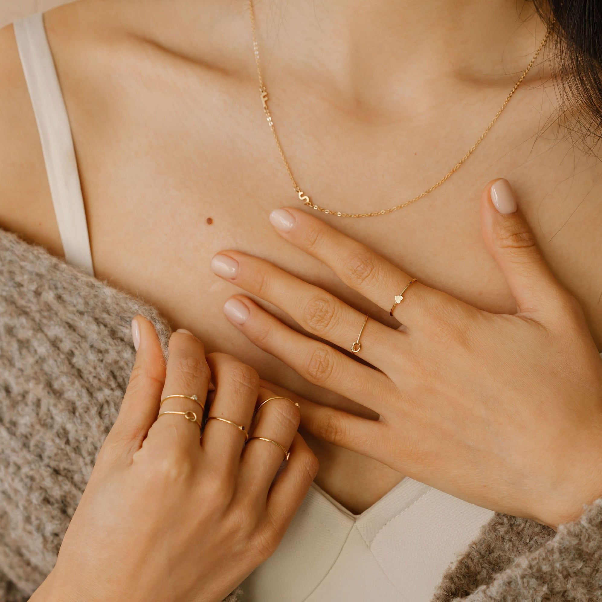 Woman wearing custom sideways initial letter necklace